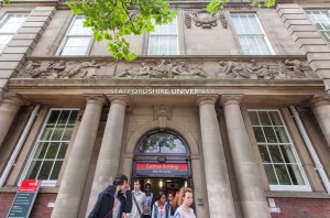 Exterior of the Cadman building with students coming out of the main door