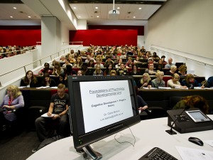 Science centre lecture theatre with students making notes