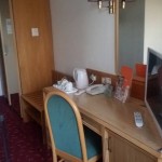 Hotel room with desk and TV