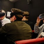 Staff members experiencing the Virtual reality campus tour on the Great Minds Bus