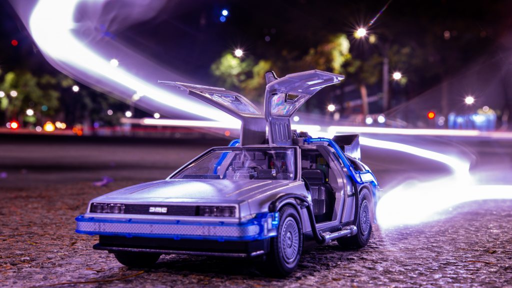 Decorative image of a toy DeLorean car like the one used as a time machine in the film Back to the Future 